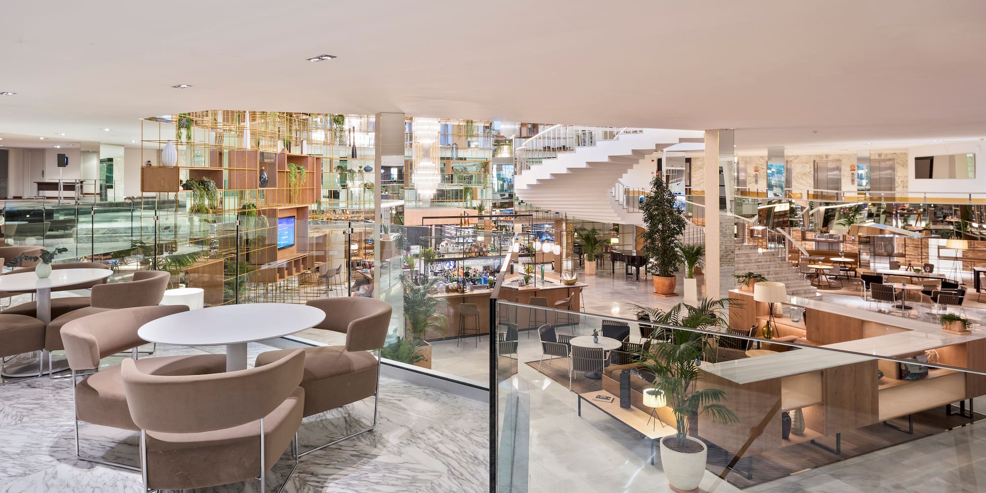 a room with a staircase and tables and chairs