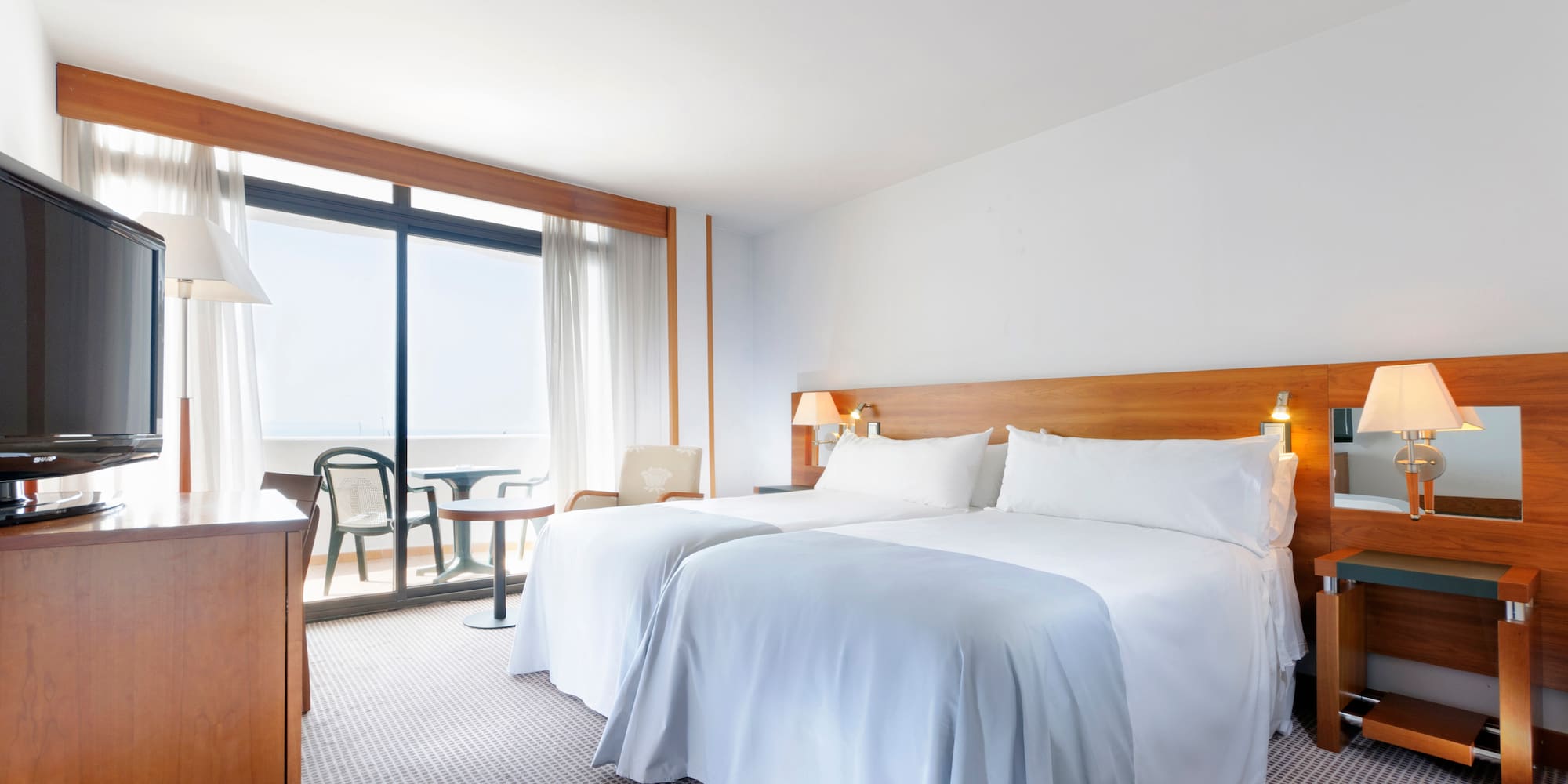 a room with two beds and a table