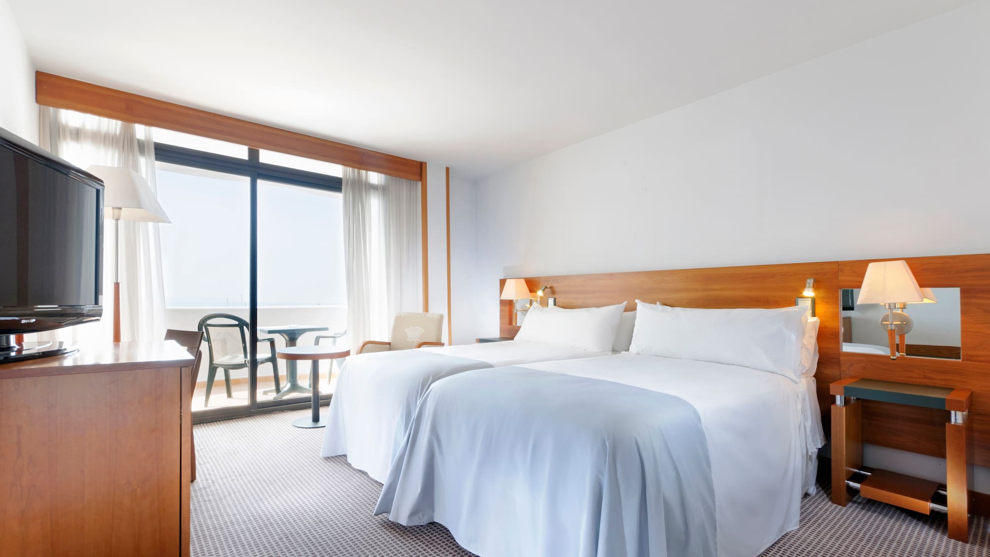 a room with two beds and a table