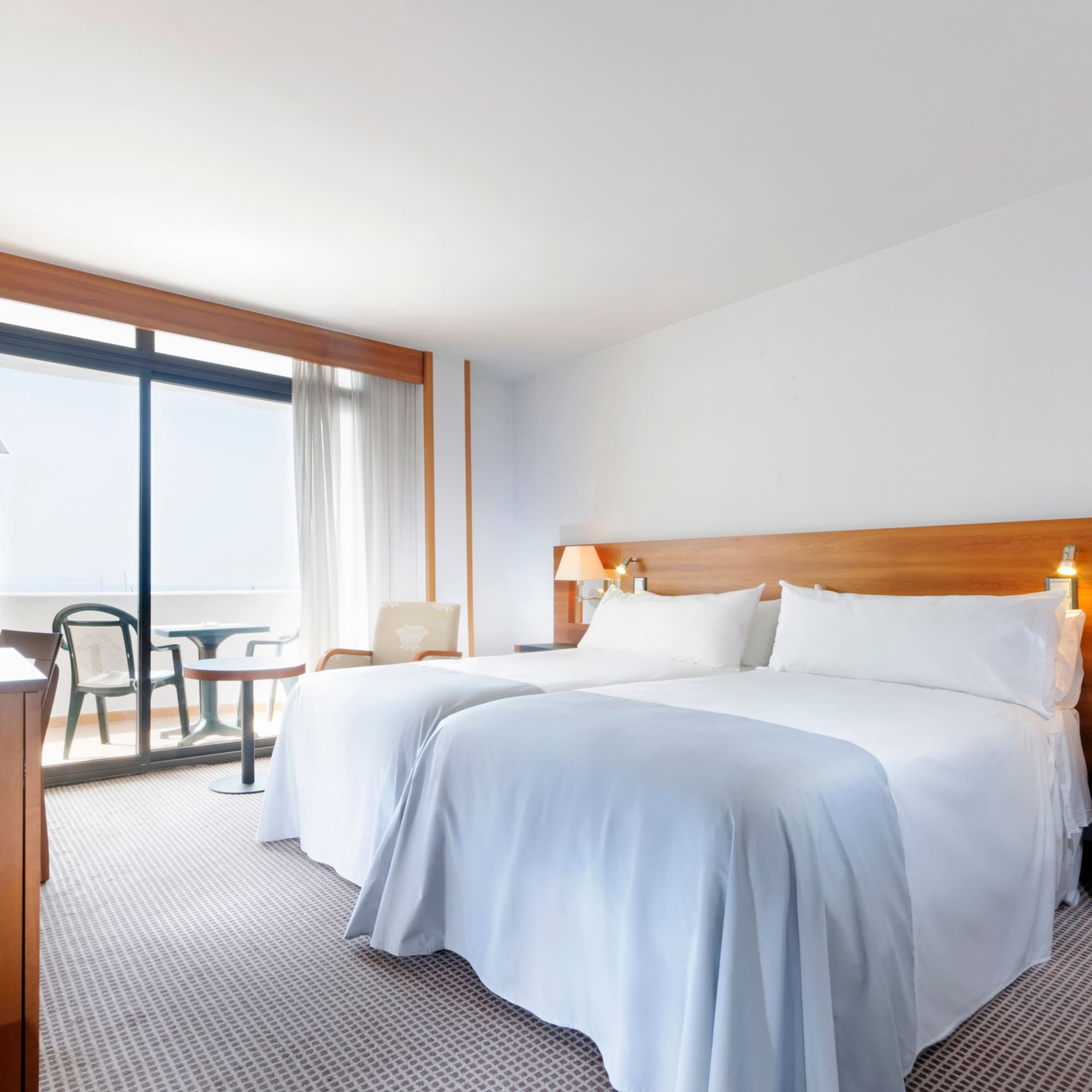 a room with two beds and a table