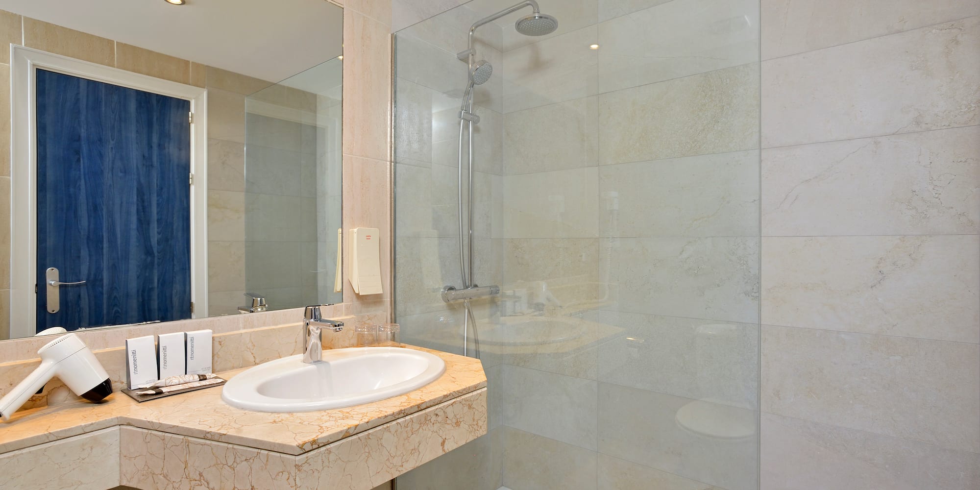 a bathroom with a shower and sink