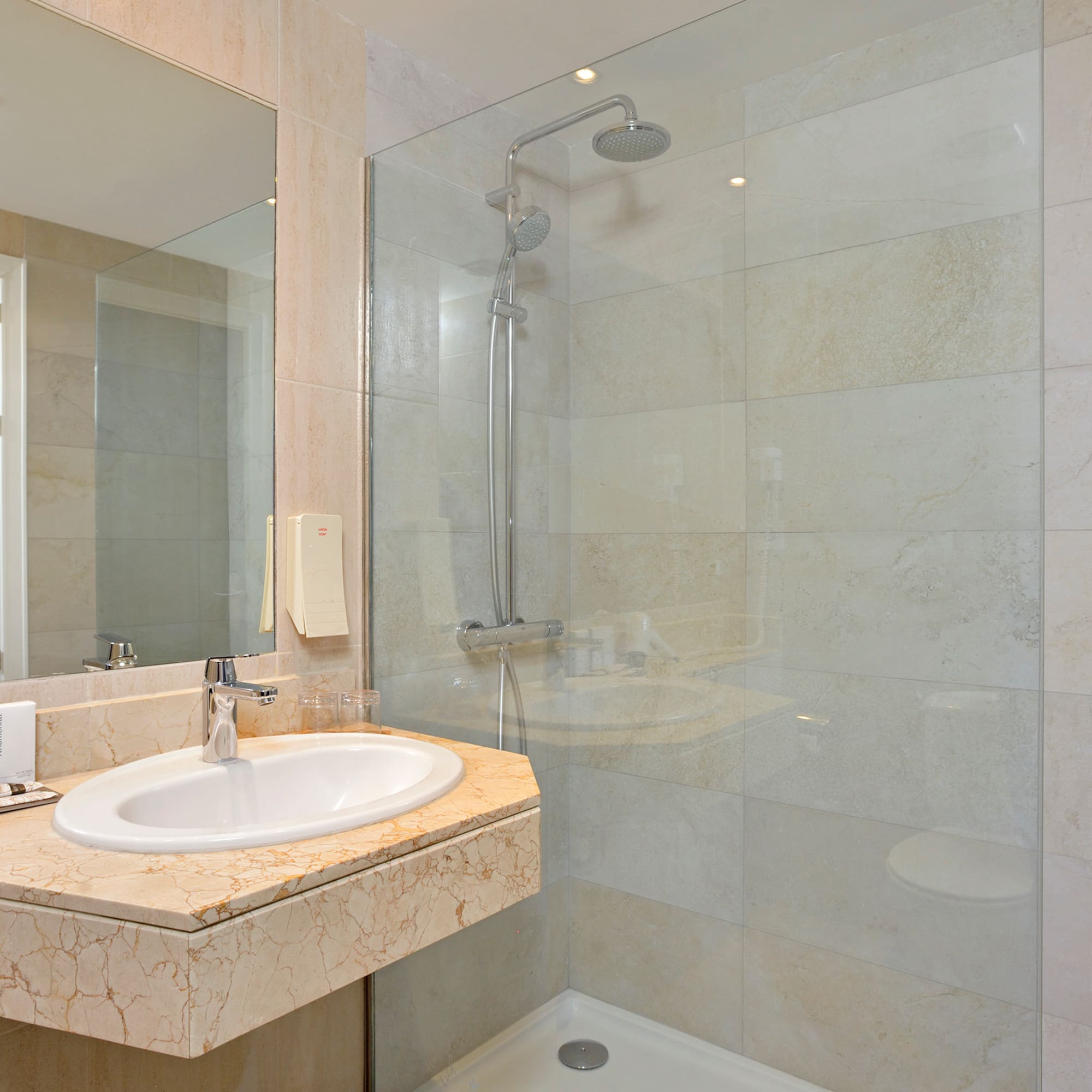 a bathroom with a shower and sink