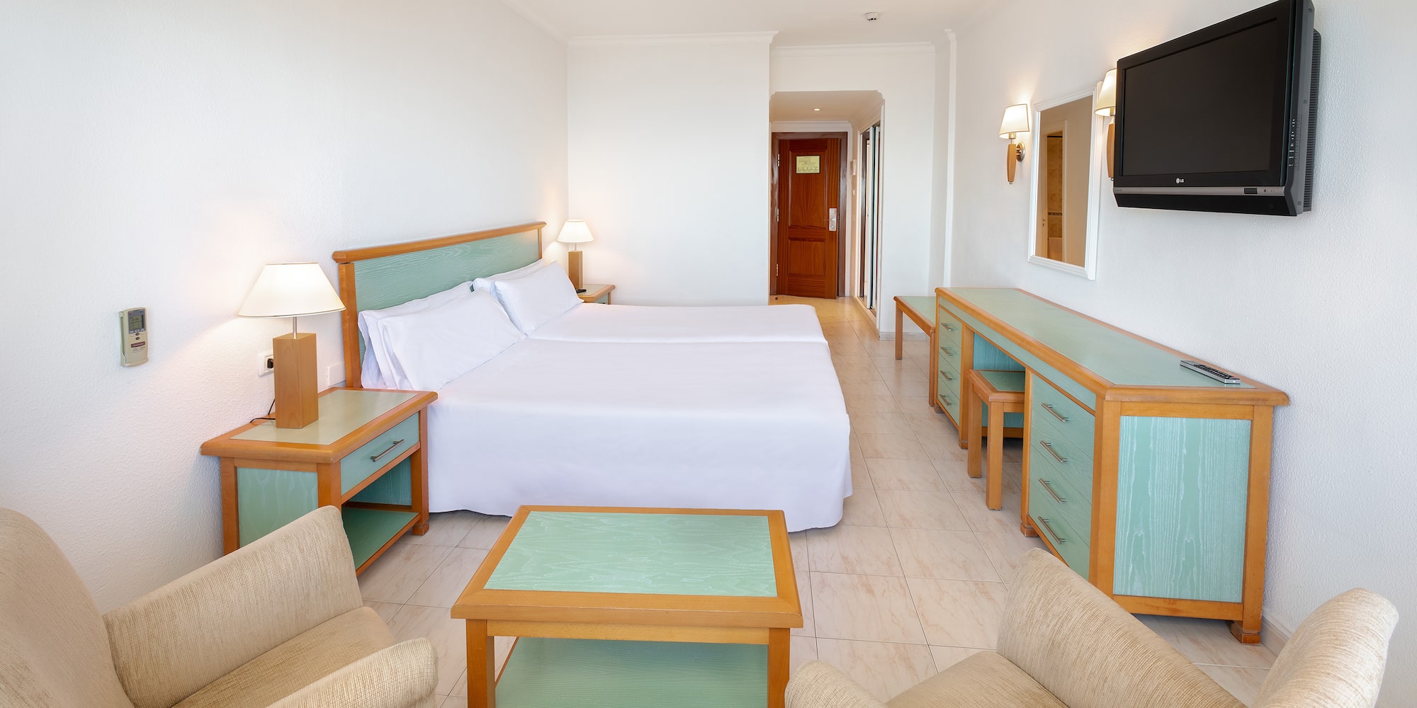 a room with two beds and a television