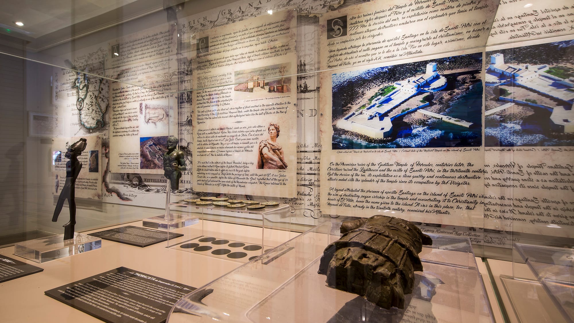 a display of a museum with a statue and pictures