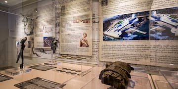 a display of a museum with a statue and pictures