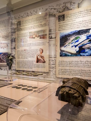 a display of a museum with a statue and pictures