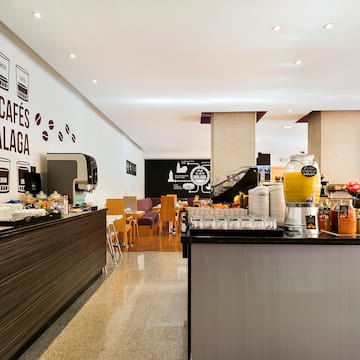 a coffee shop with a counter and a wall with black and white graphics