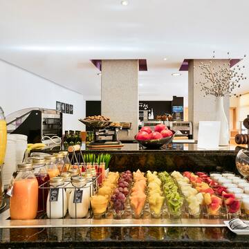 a buffet table with different drinks and fruits