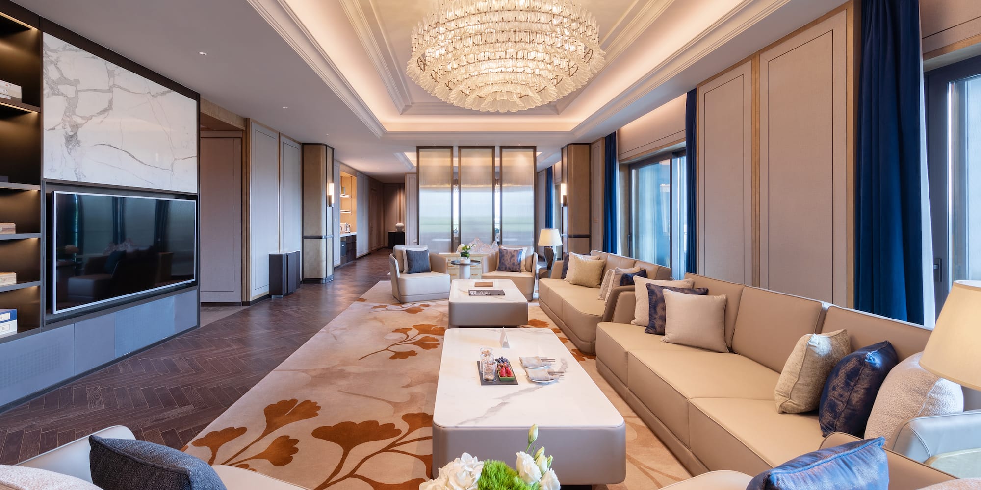 a room with a chandelier and couches