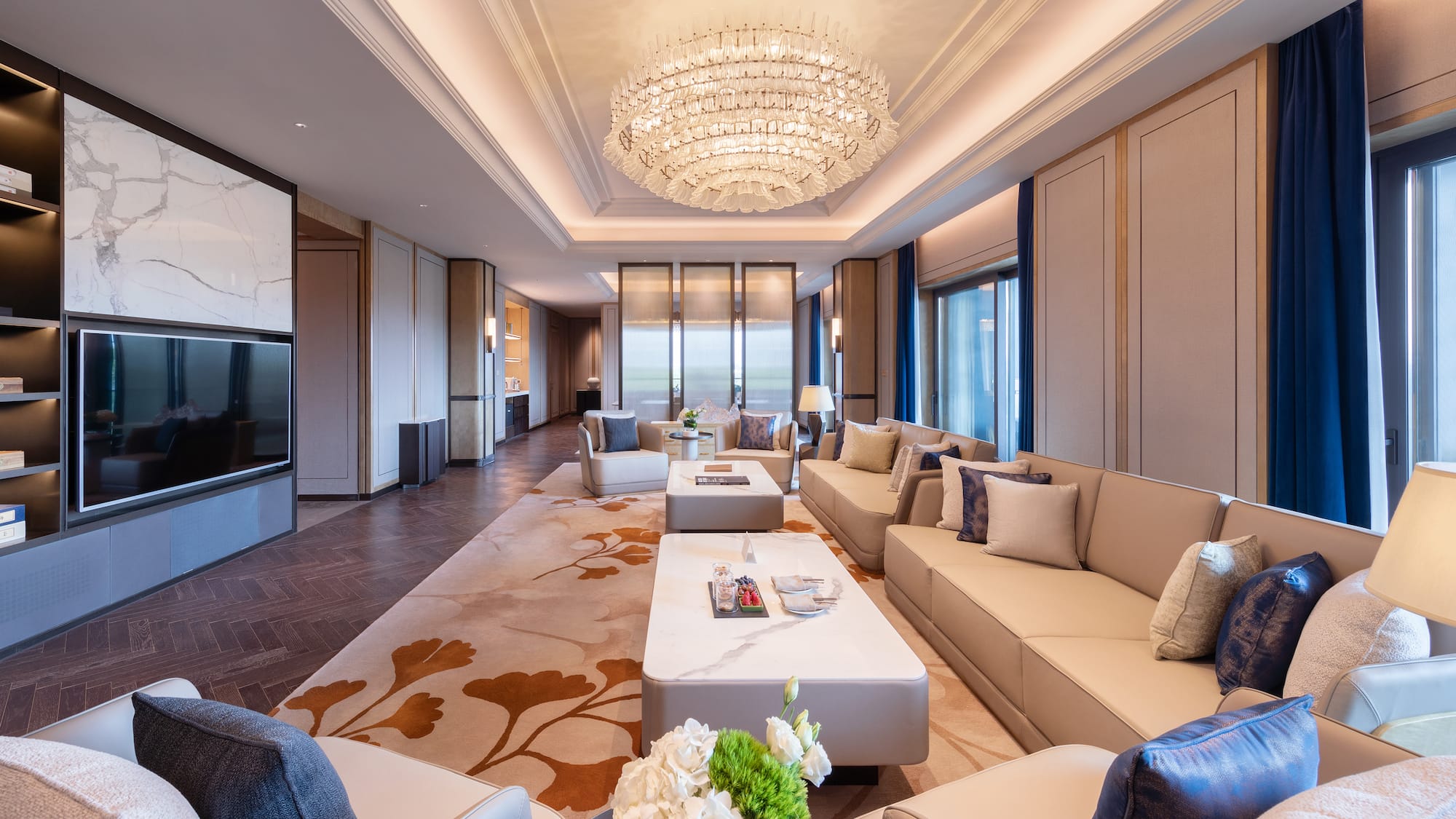 a room with a chandelier and couches