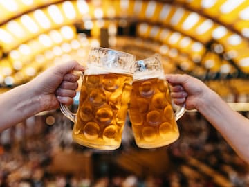 a pair of hands clinking glasses of beer