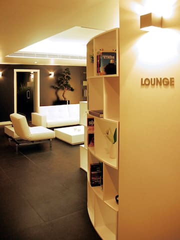 a lounge room with white furniture