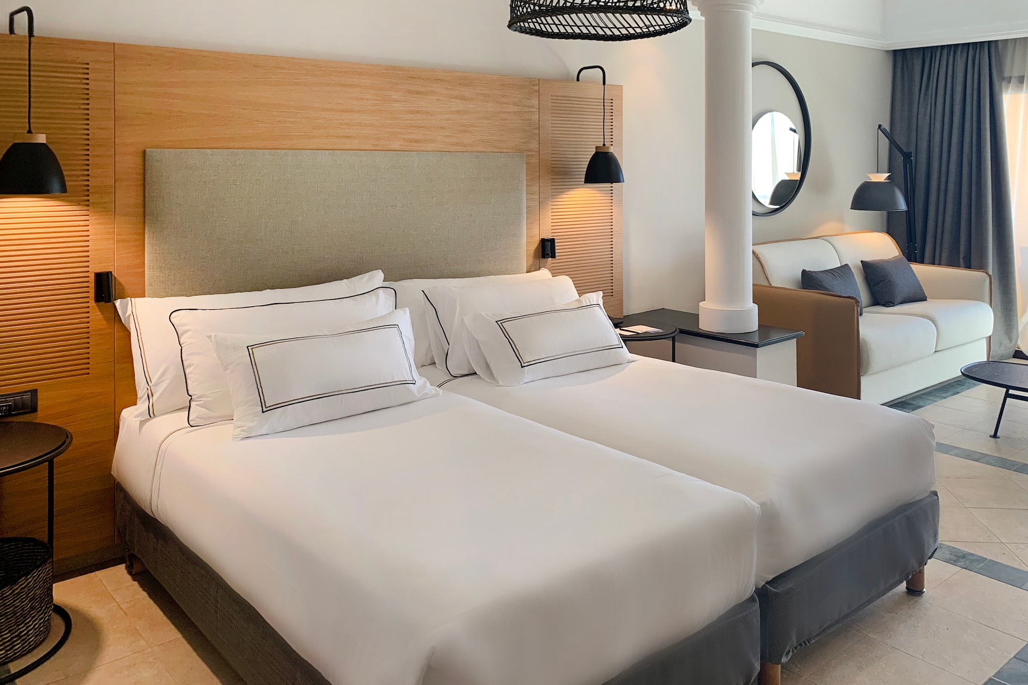 a room with two beds and a lamp