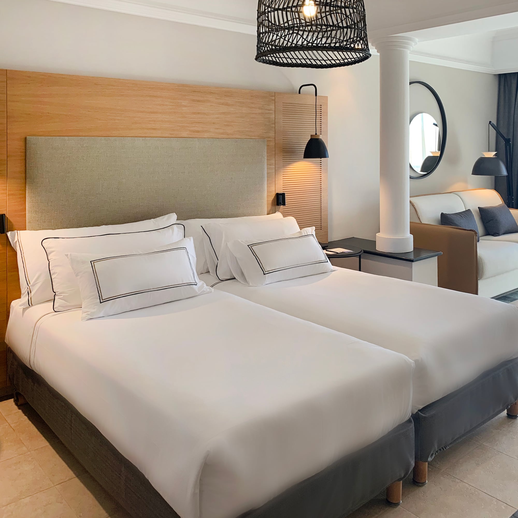 a room with two beds and a lamp