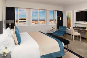 a bedroom with a bed and chairs