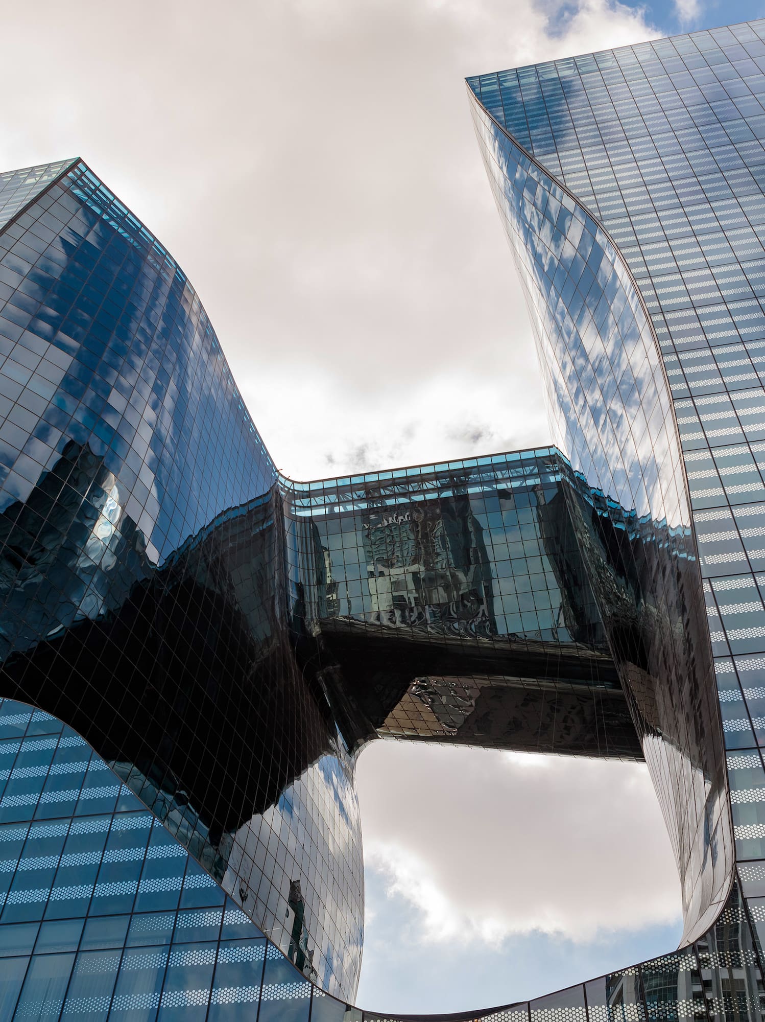 a glass building with a curved design