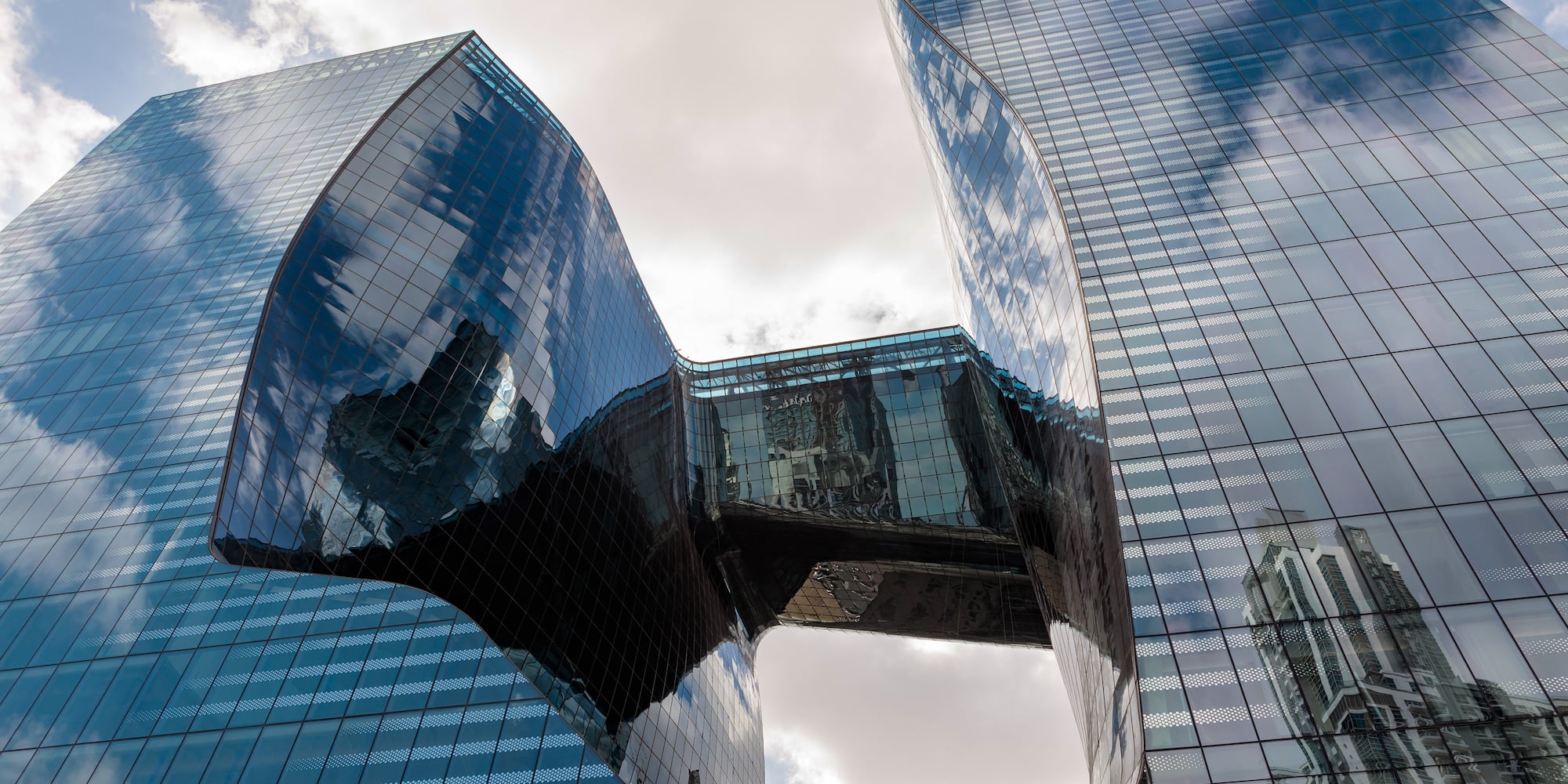 a glass building with a curved design