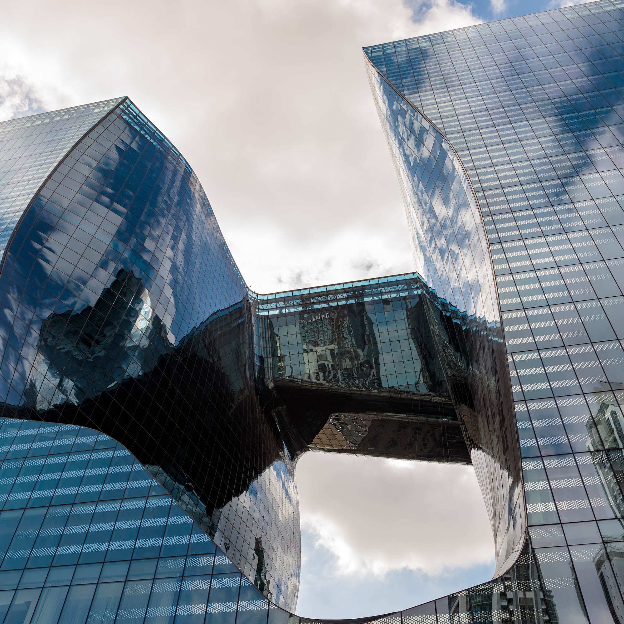 a glass building with a curved design