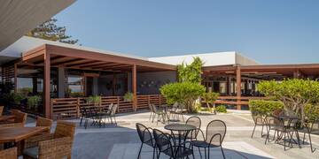 a patio with chairs and tables