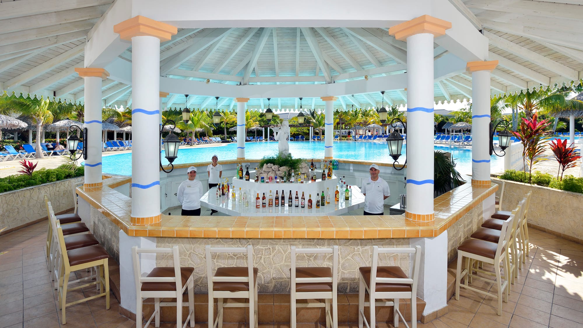 a group of people standing behind a bar