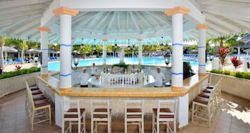 a group of people standing behind a bar