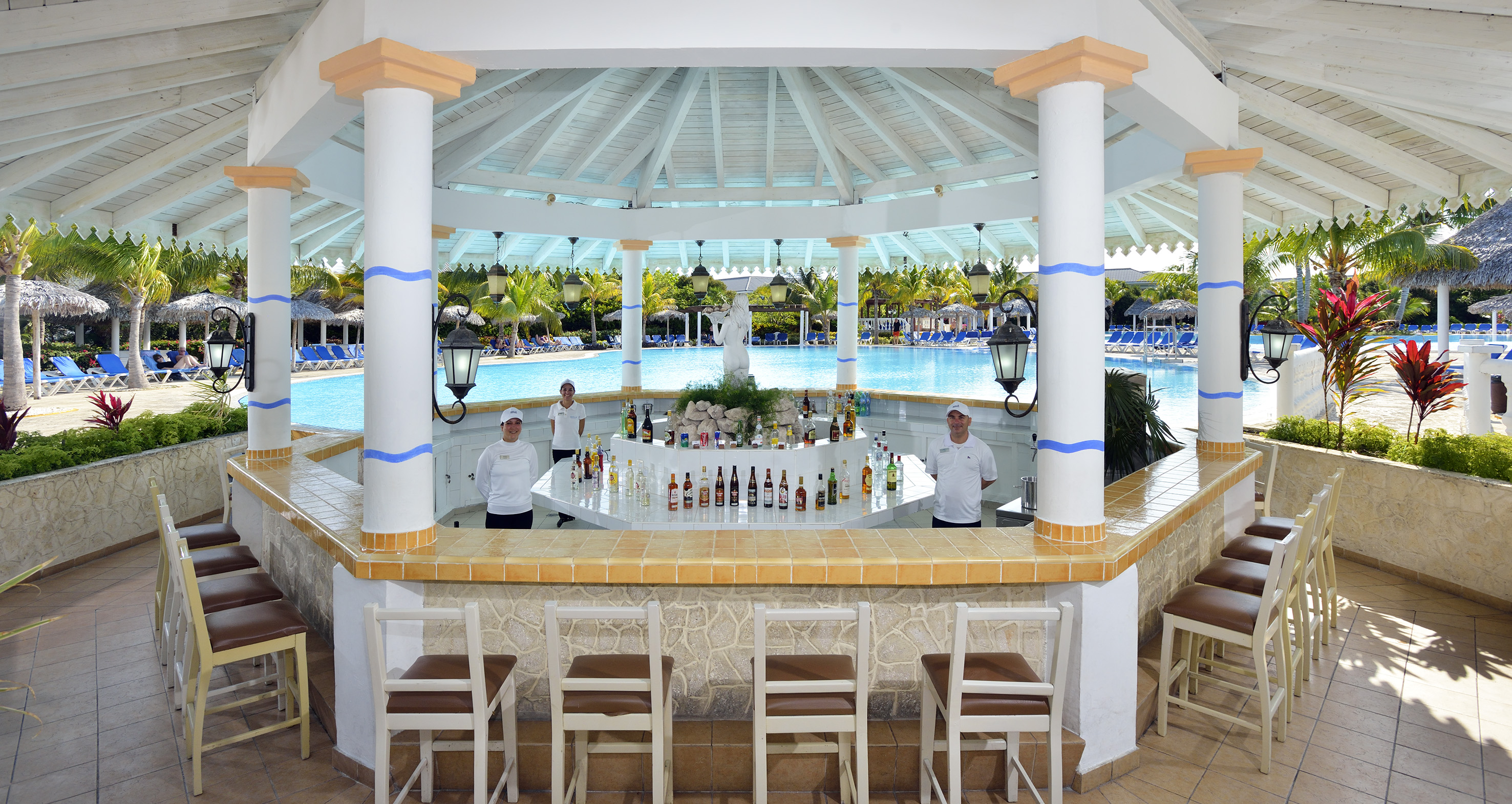 a group of people standing behind a bar