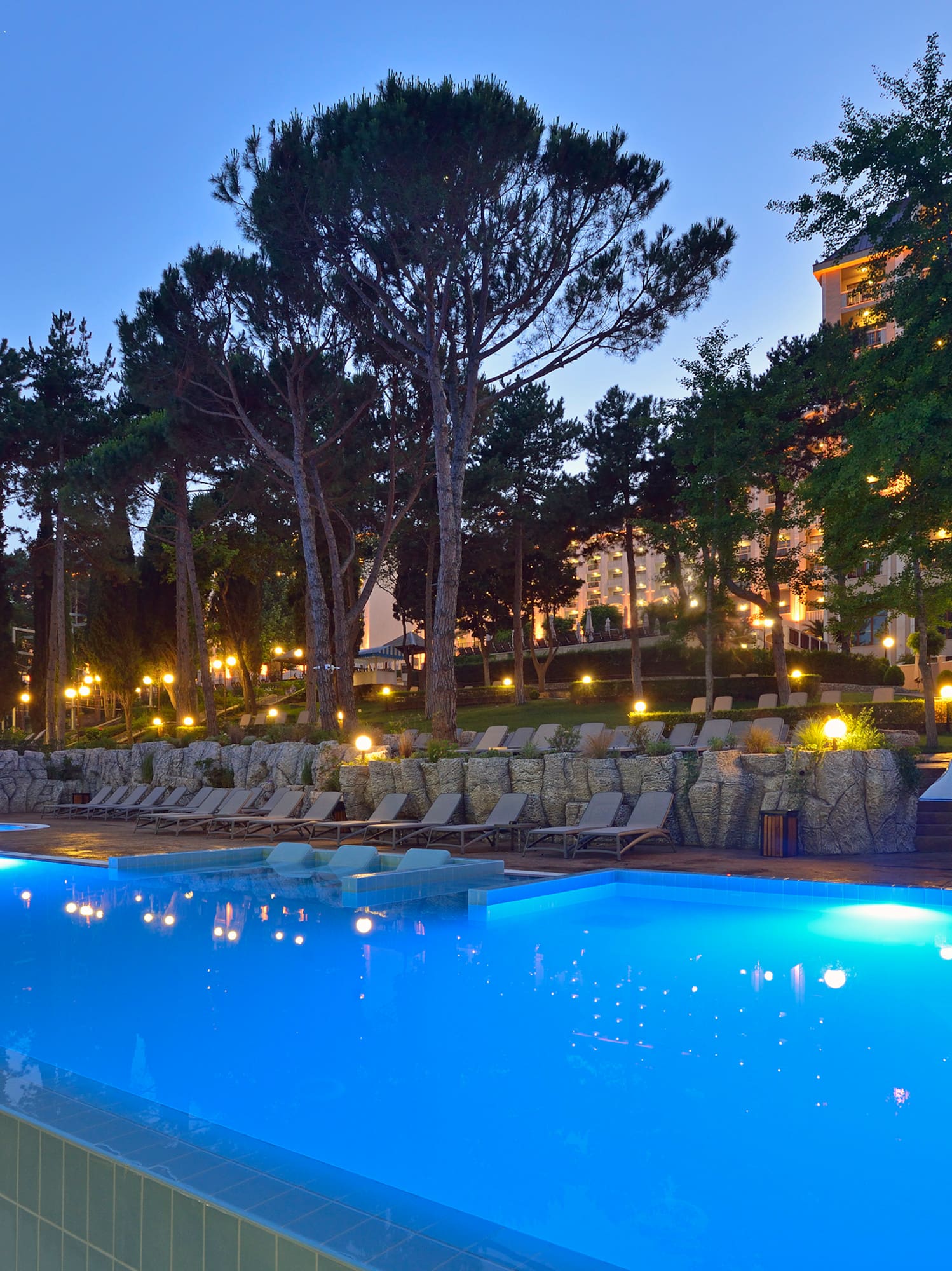 a pool with lights on the side