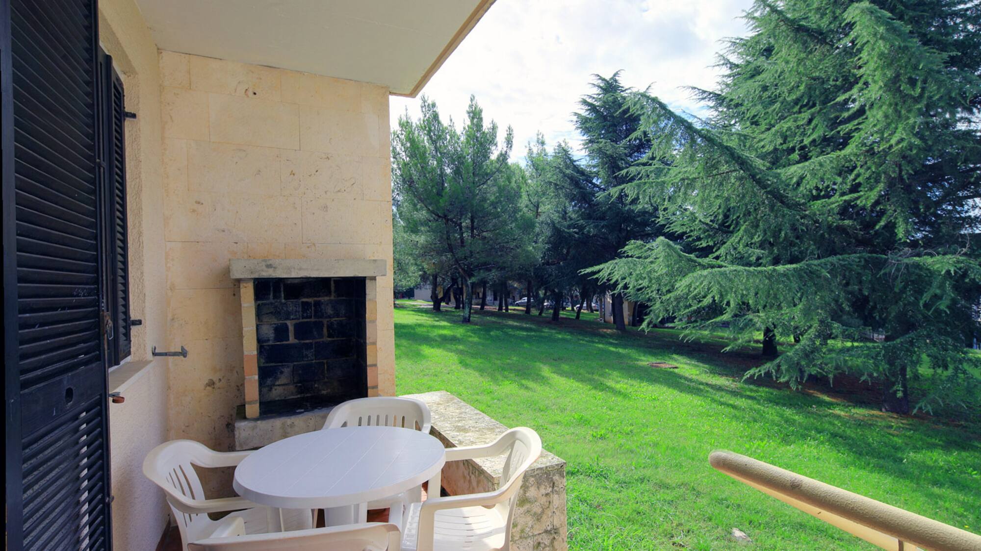a patio with chairs and a table