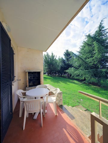 a patio with chairs and a table