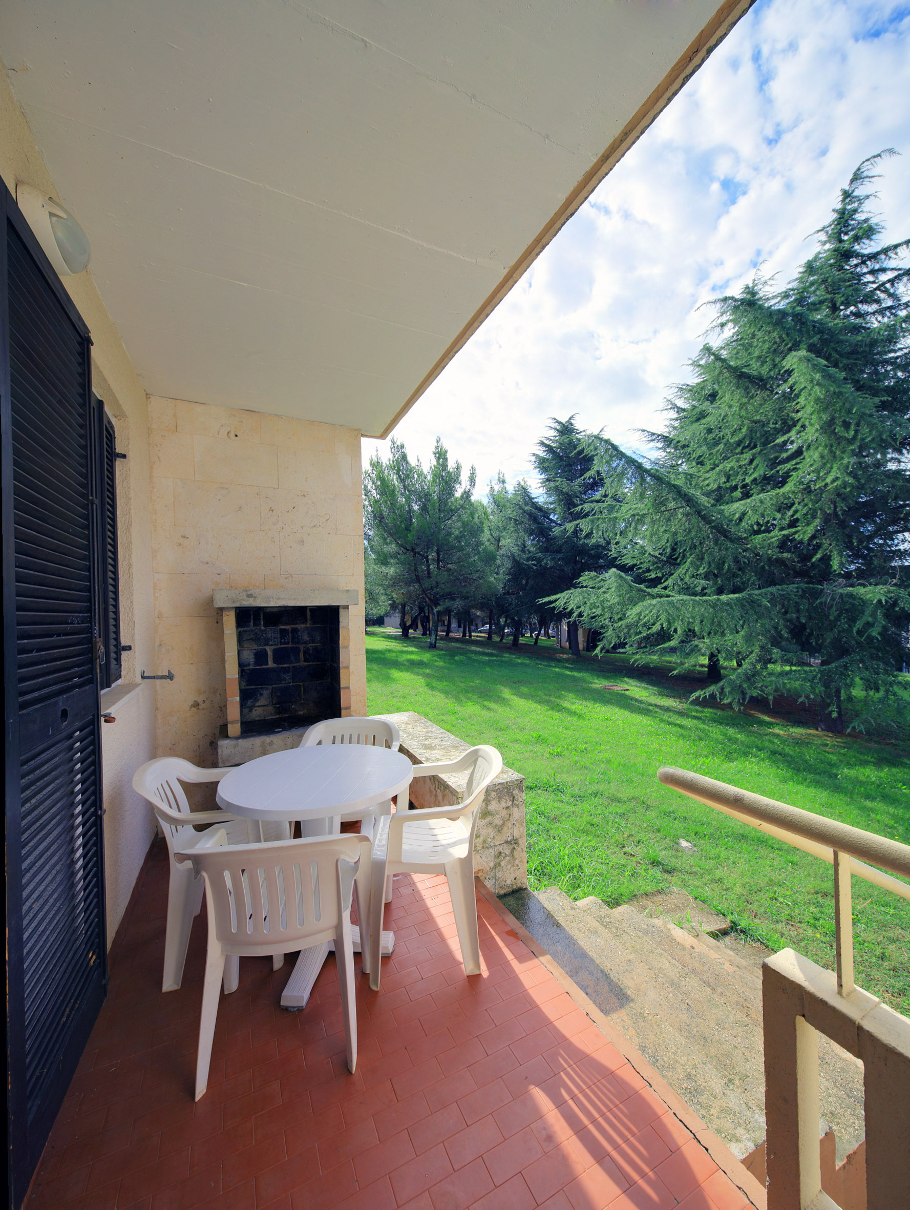 a patio with chairs and a table