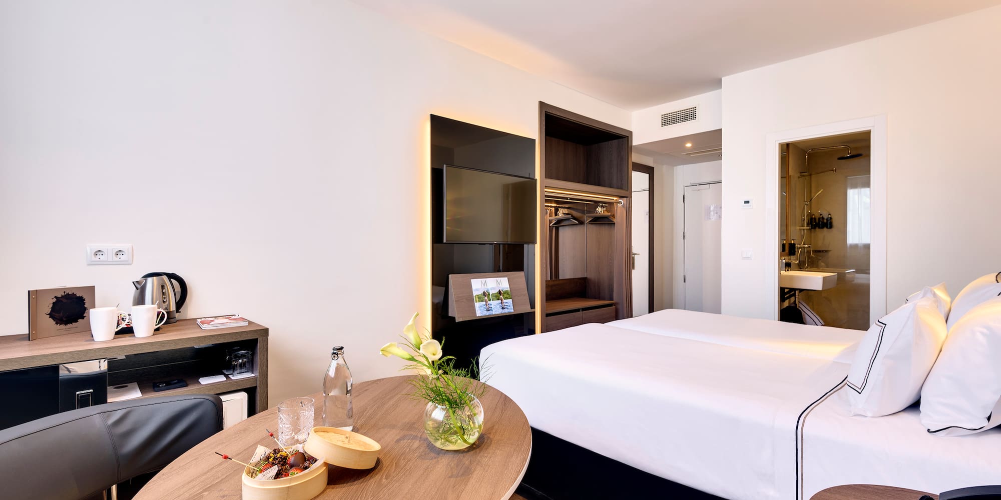 a room with a bed and a television