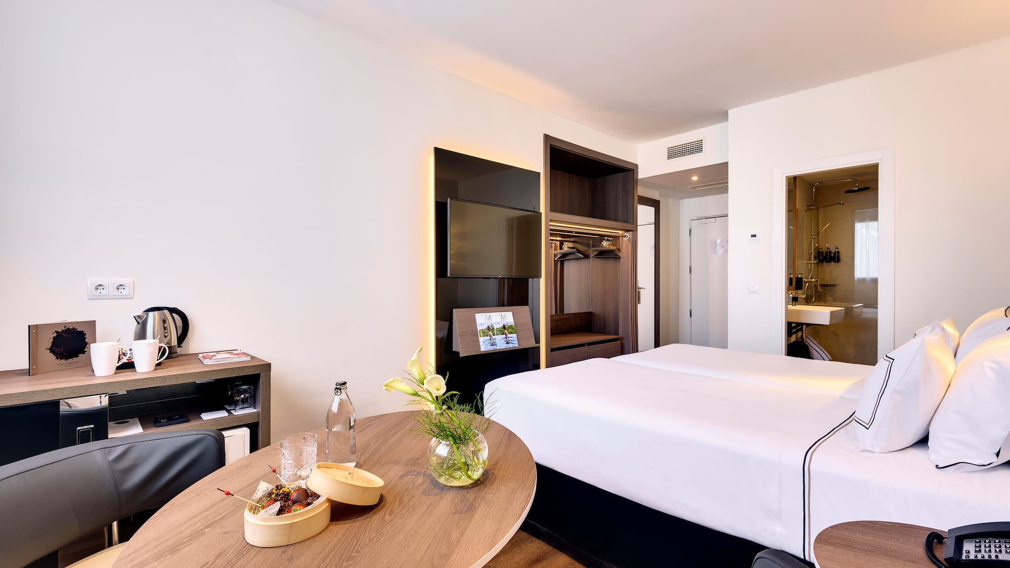 a room with a bed and a television