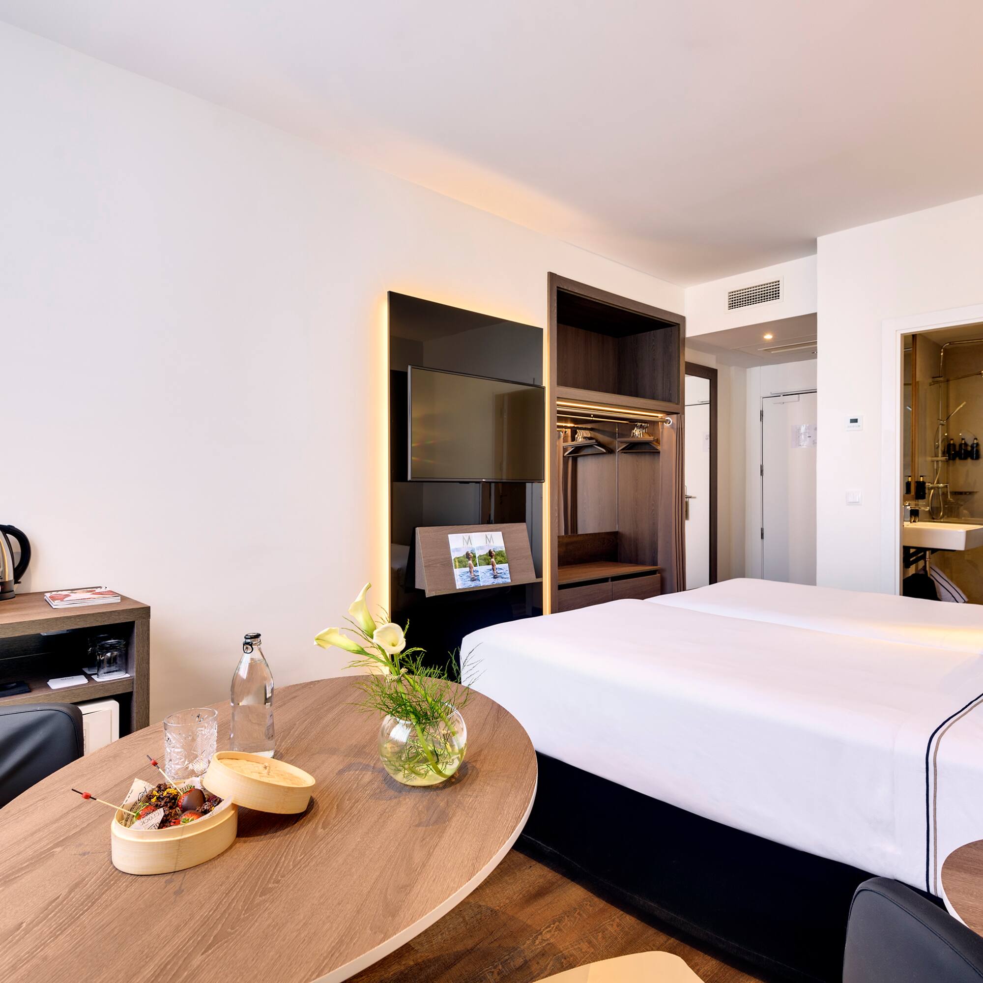 a room with a bed and a television