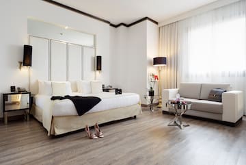 a bedroom with a bed and a couch