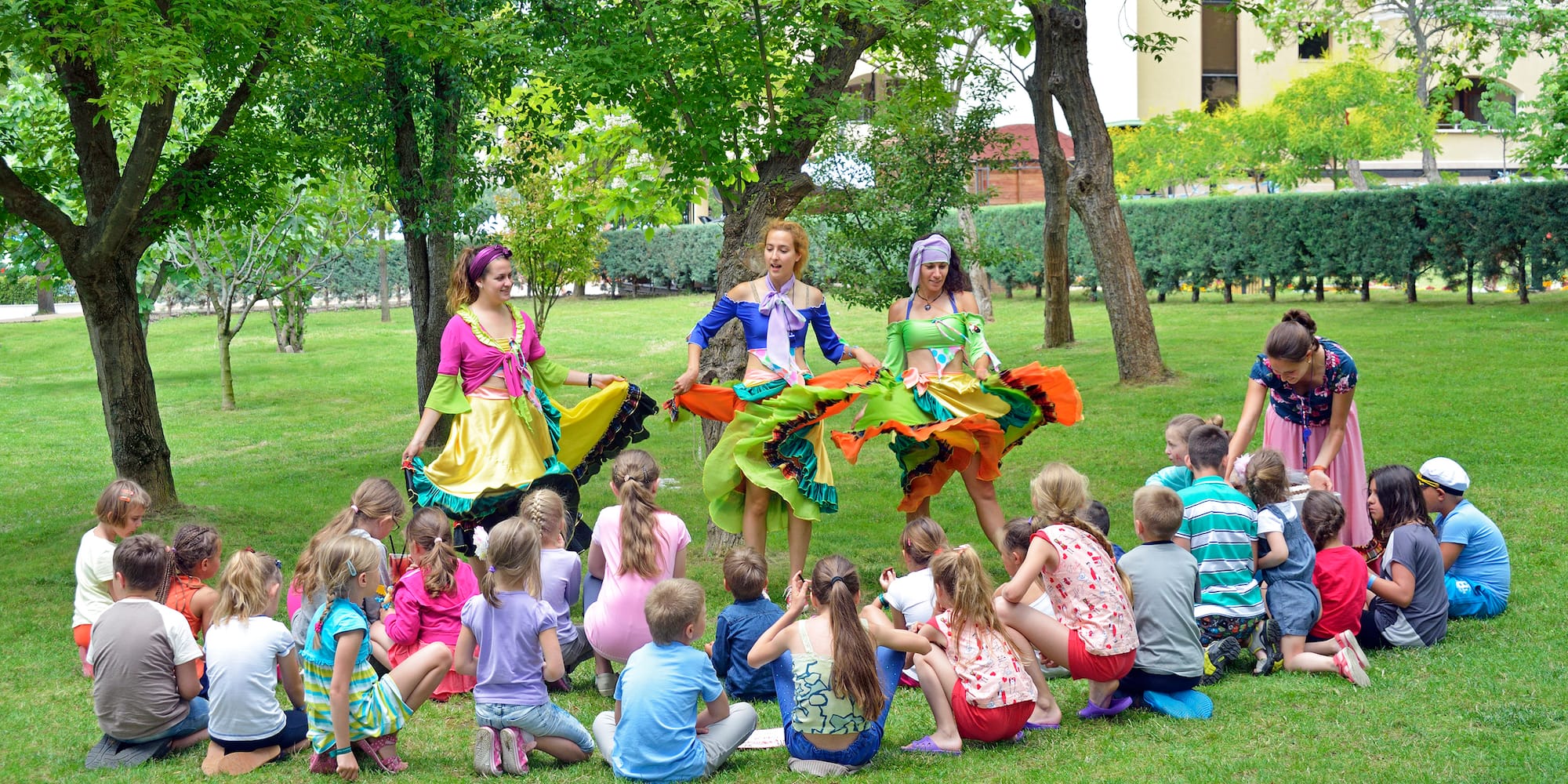 a group of people in colorful dresses performing a circle of dancing