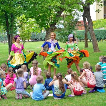 a group of people in colorful dresses performing a circle of dancing