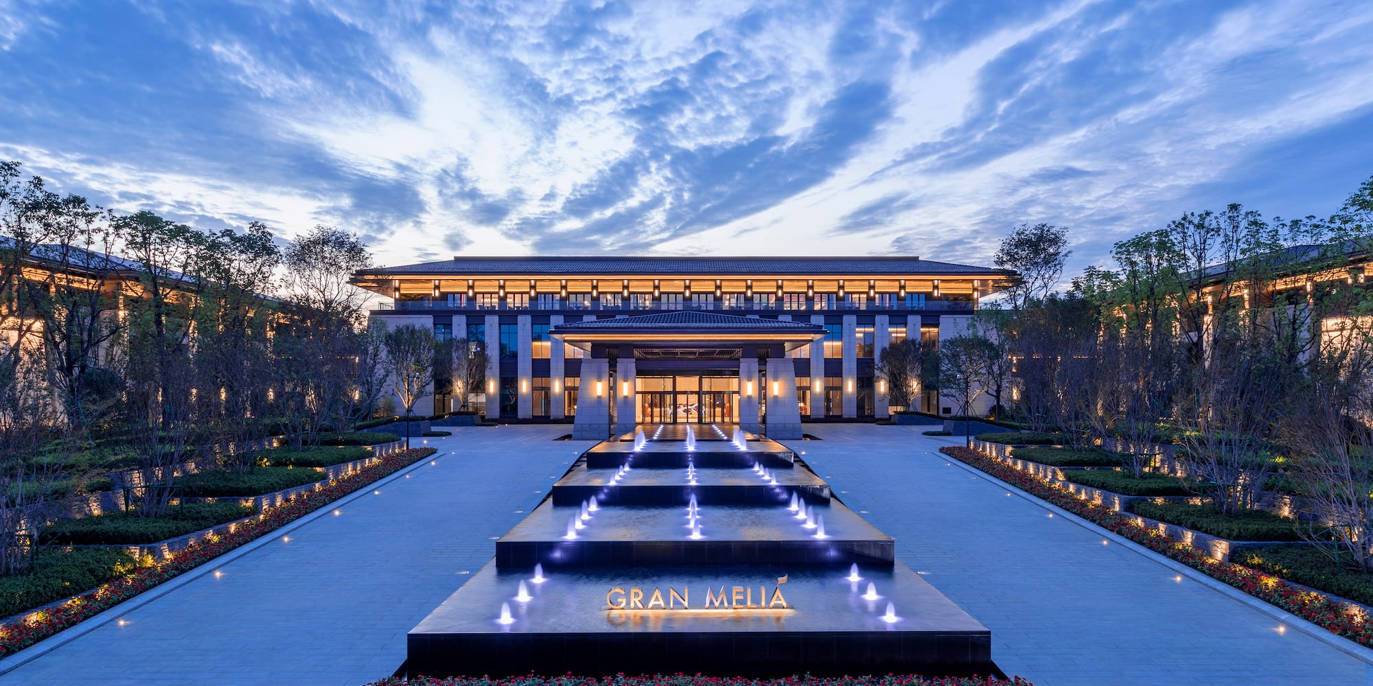 a building with a fountain and trees