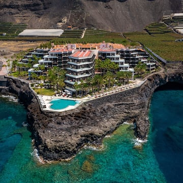 a building on a cliff above water