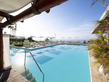 a pool with chairs and umbrellas