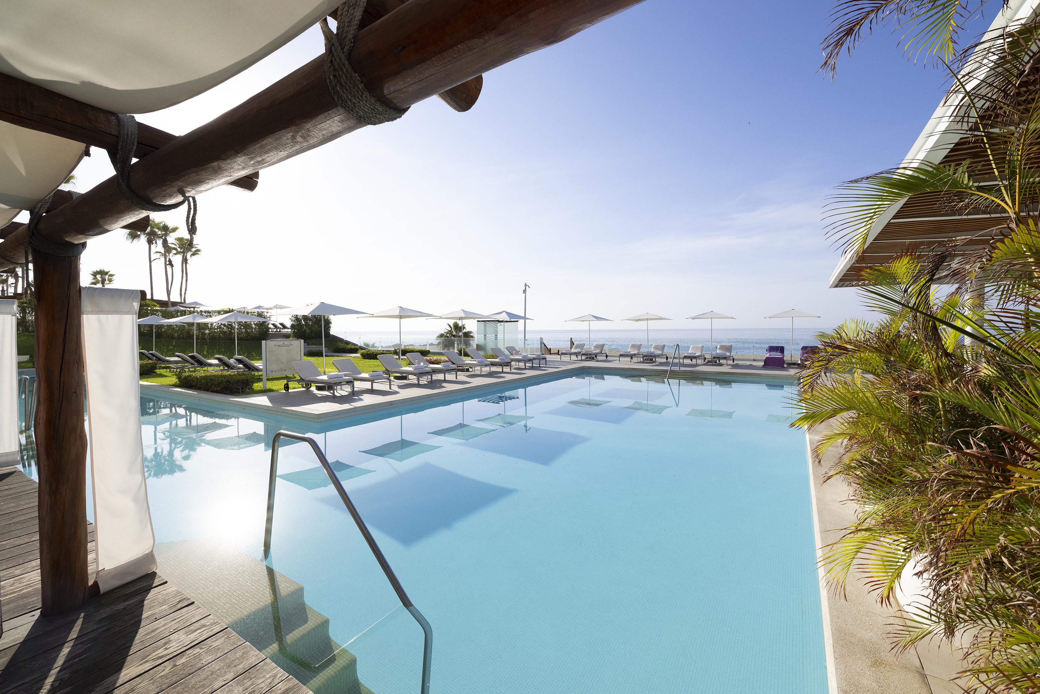 a pool with chairs and umbrellas
