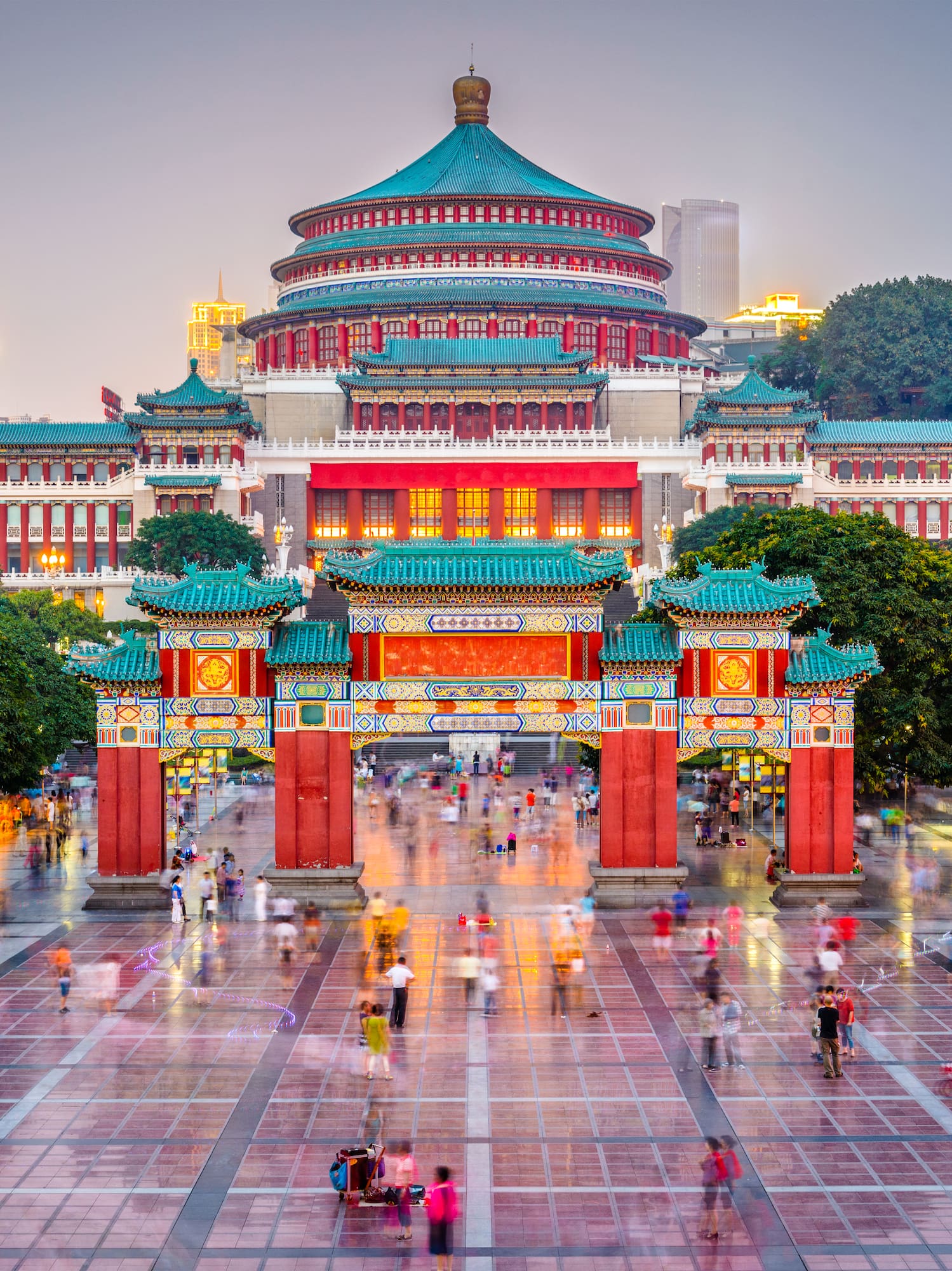 a large building with a domed roof and trees