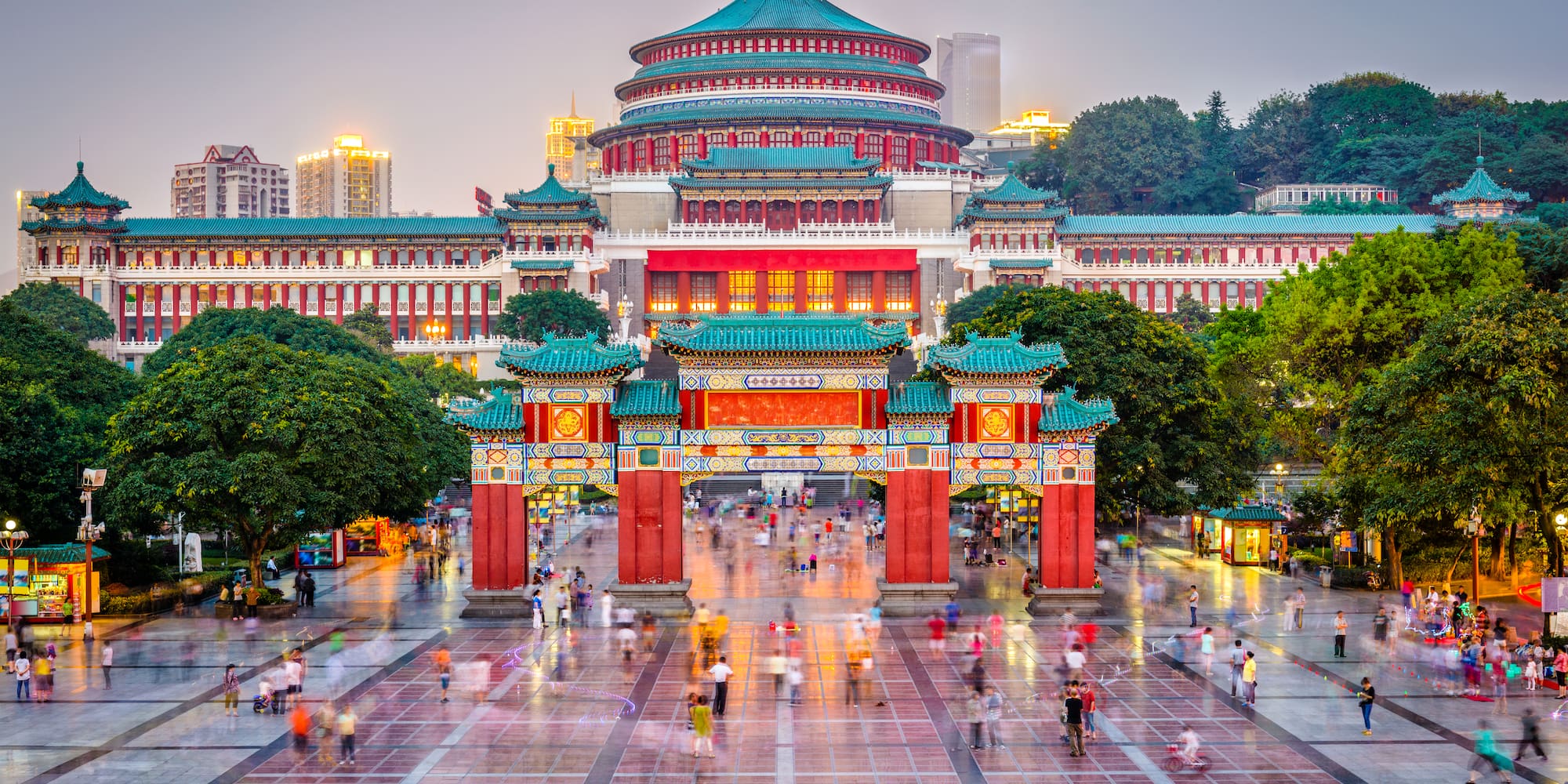 a large building with a domed roof and trees