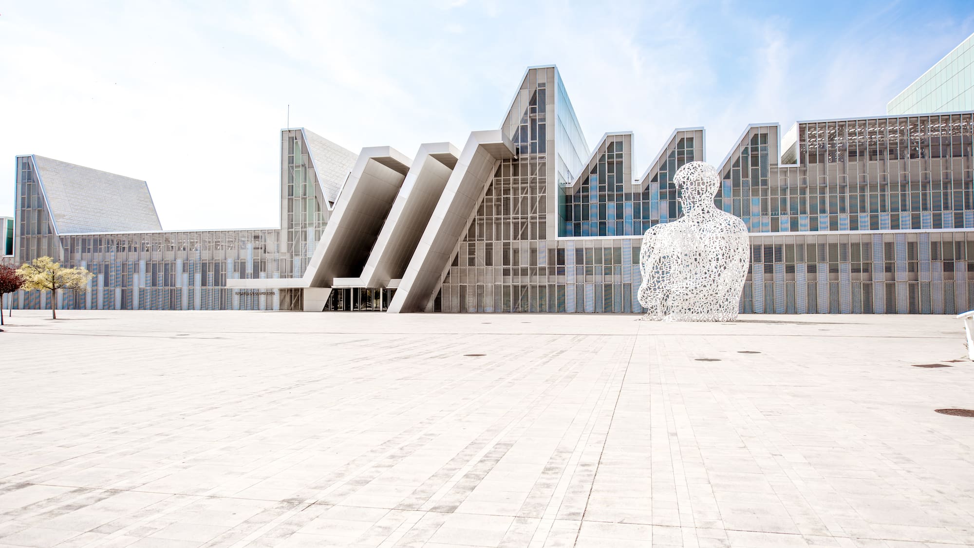 a large white statue in front of a building