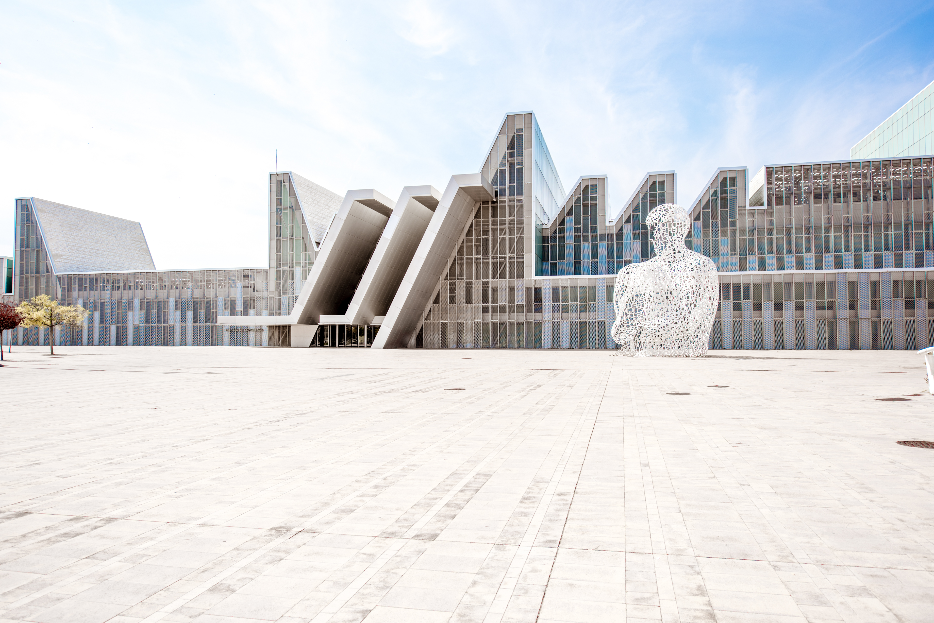 a large white statue in front of a building