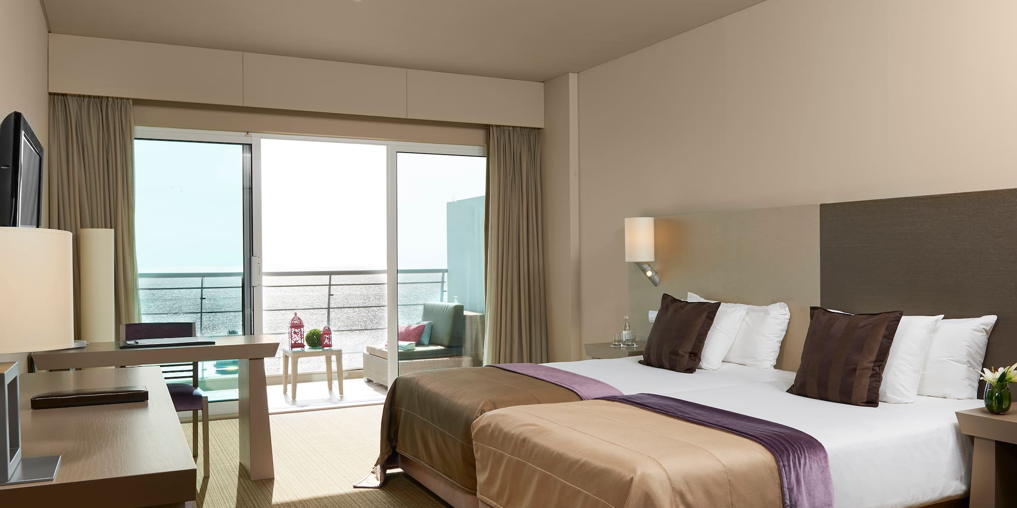 a hotel room with a large bed and a table