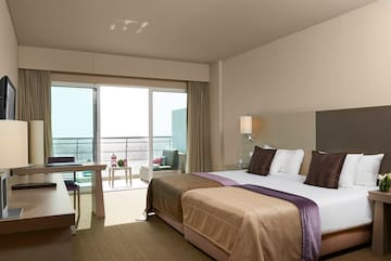 a hotel room with a large bed and a table