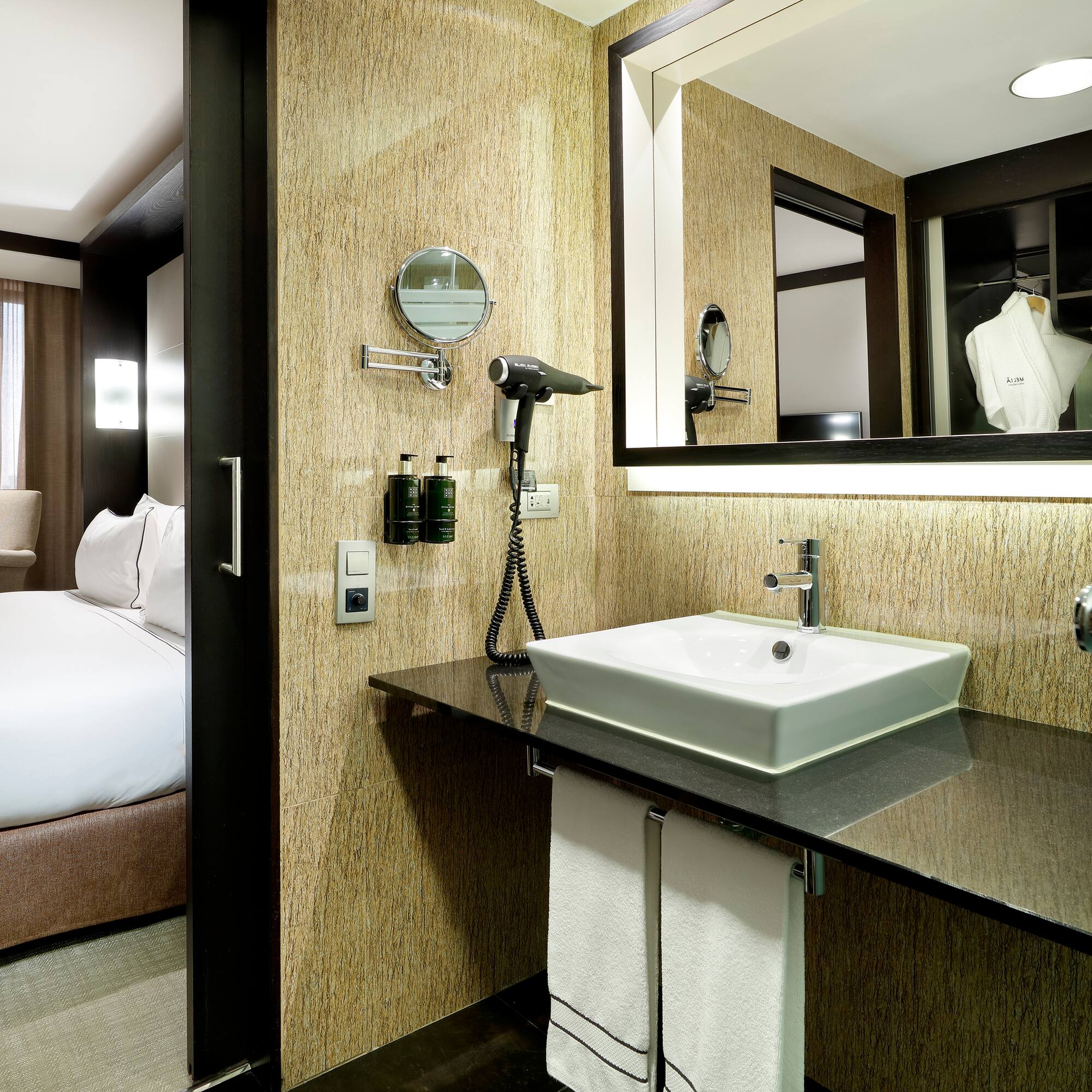 a bathroom with a mirror and a sink