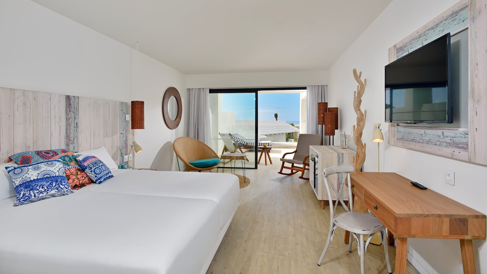 a room with two beds and a desk and chair