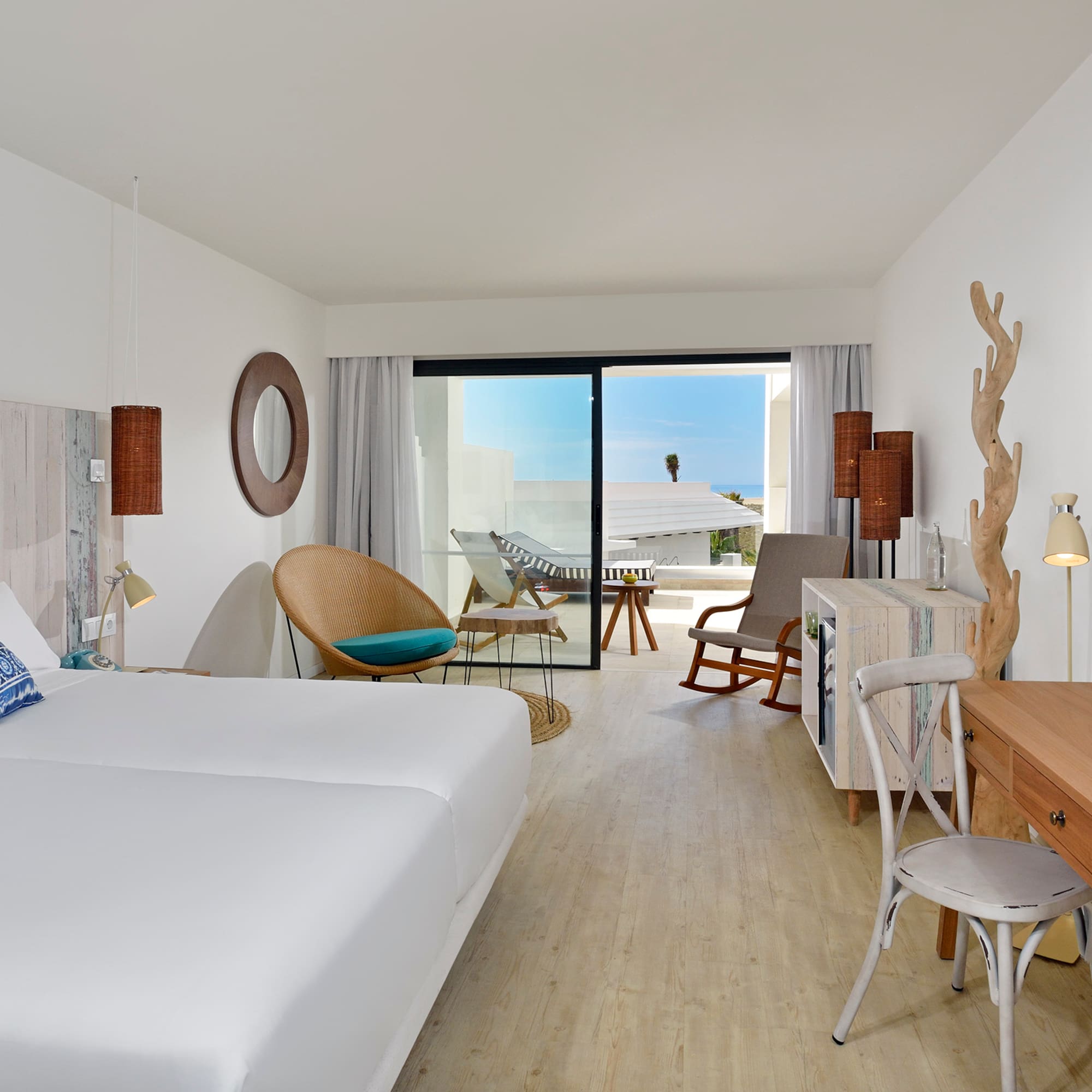 a room with two beds and a desk and chair