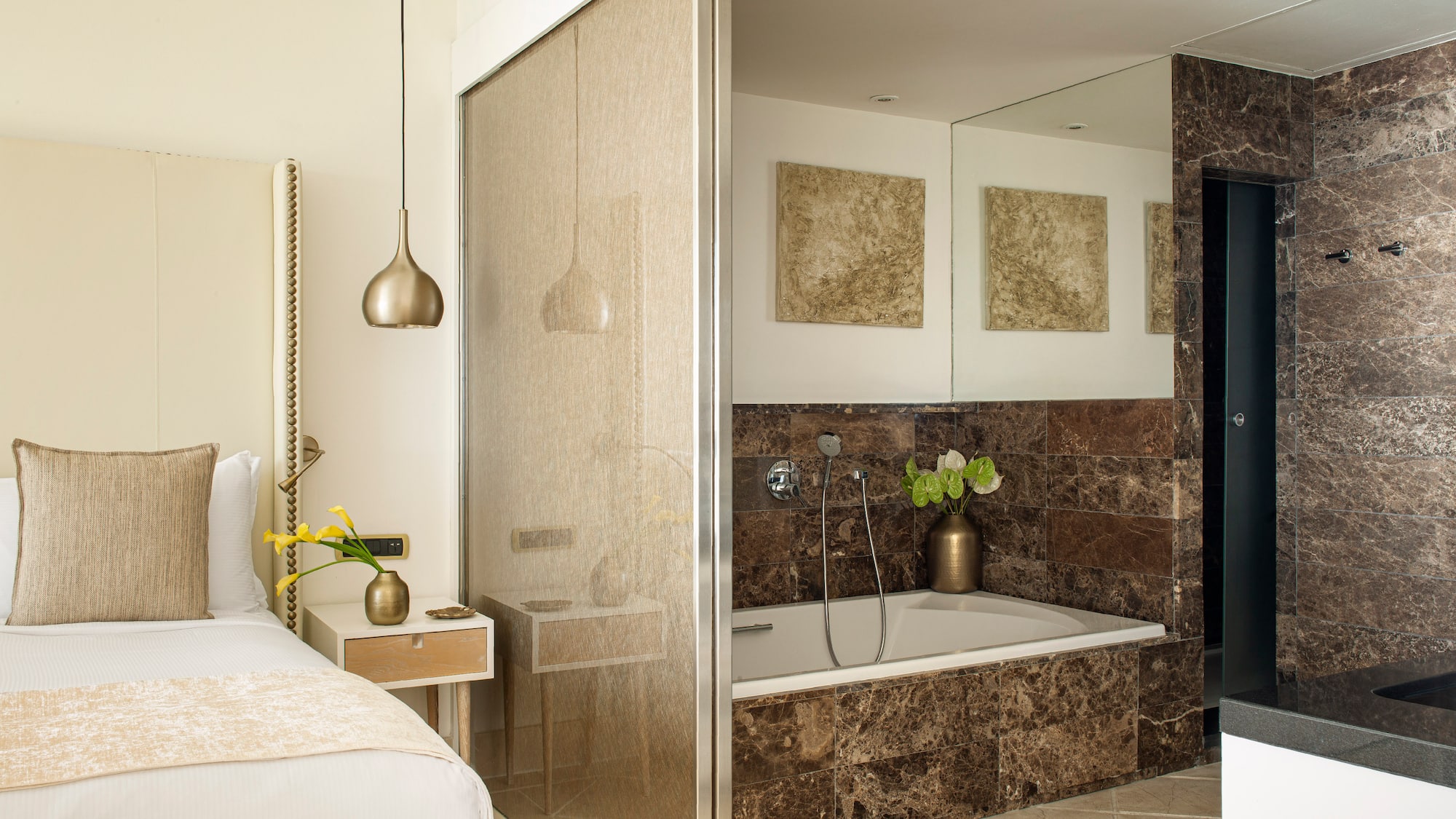 a bathroom with a bathtub and a bed